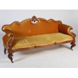 A 19th century mahogany sofa, the ochre coloured velvet upholstered back, arms and serpentine seat