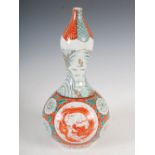 A late 19th/early 20th century Japanese porcelain gourd shaped vase, decorated with two dragon
