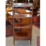 A 19th century mahogany four tier what-not, with single frieze drawer and tapered cylindrical