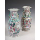 A pair of Chinese porcelain famille rose Canton vases, Qing Dynasty, decorated with panels of