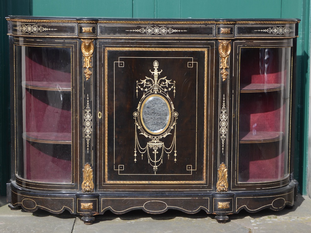 A Victorian ebonised, ivory inlaid and ormolu mounted credenza, the central panelled cupboard door