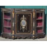 A Victorian ebonised, ivory inlaid and ormolu mounted credenza, the central panelled cupboard door