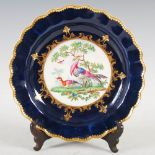 An 18th century Worcester cobalt blue ground plate, circa 1770, decorated with two colourful birds