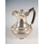 A George V silver hot water pot, London, 1910, makers mark of B&S, the beaded rim with shell and