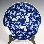 A Japanese porcelain blue and white charger, early 20th century, decorated with prunus blossom, 31cm