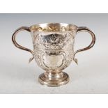 A George II silver loving cup, London, 1735, with later embossed foliate and scroll decoration, on a