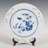 A Chinese porcelain blue and white plate, Qing Dynasty, decorated with rock work issuing bamboo