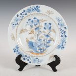 A Chinese porcelain blue and white plate, Qing Dynasty, decorated with birds perching in peony and