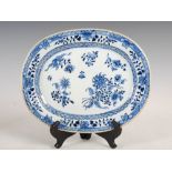 A Chinese porcelain blue and white oval shaped meat plate, Qing Dynasty, decorated with scattered
