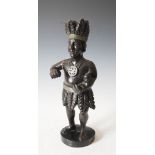 A 19th century carved and ebonised wood tobacco advertising figure of a West Indian taking snuff,