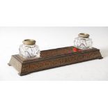 A late 19th century red boulle desk stand, the rectangular dished pen tray flanked by cut glass