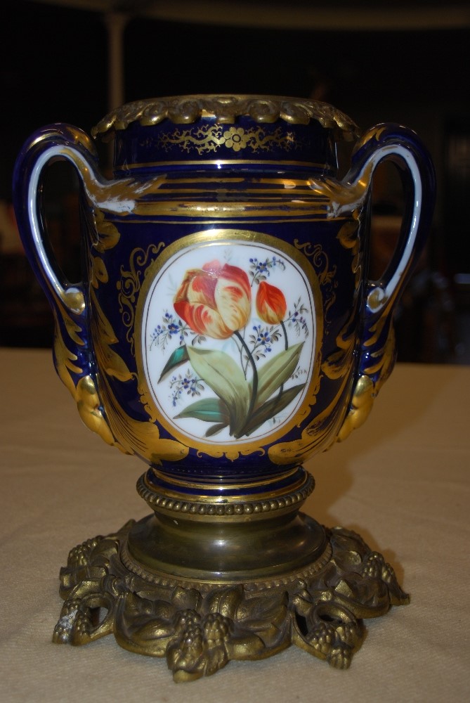 LATE 19TH CENTURY GILT METAL MOUNTED PORCELAIN COBALT BLUE GROUND TWIN HANDLED URN DECORATED WITH