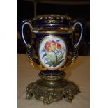 LATE 19TH CENTURY GILT METAL MOUNTED PORCELAIN COBALT BLUE GROUND TWIN HANDLED URN DECORATED WITH