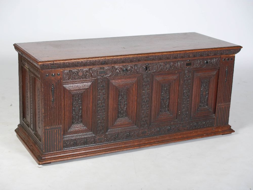 A 19th century Continental oak and ebony inlaid baroque style coffer, the hinged rectangular top