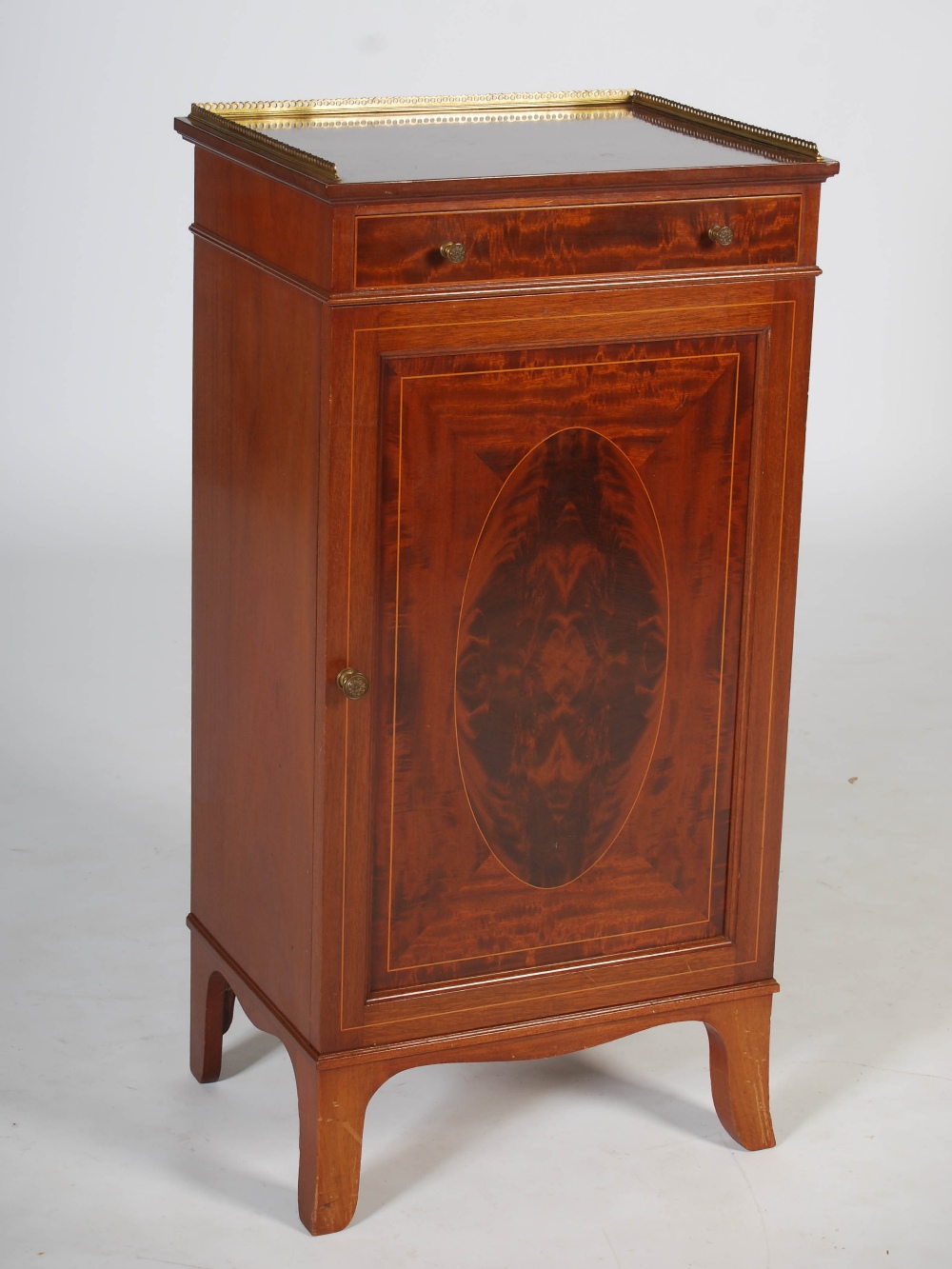 An Edwardian mahogany and boxwood lined music cabinet, the rectangular top with pierced brass