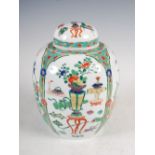 A Chinese porcelain famille verte jar and cover, decorated with panels of peony and chrysanthemum