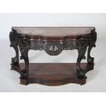 An impressive Chinese dark wood bow front console table, Qing Dynasty, the shaped top with a mottled