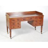 A Victorian mahogany wash stand, the rectangular top with three quarter gallery, above a central