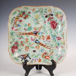 A Chinese porcelain famille rose celadon ground square shaped dish, Qing Dynasty, decorated with