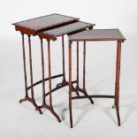 A nest of three 19th century rosewood Regency style occasional tables, the rectangular tops raised