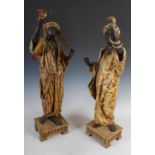 A pair of late 19th/early 20th century cold painted spelter Moorish figures, the male figure a snake