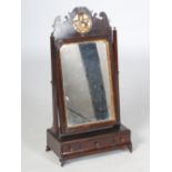 A George II mahogany and parcel gilt dressing table mirror, the hinged rectangular mirror plate
