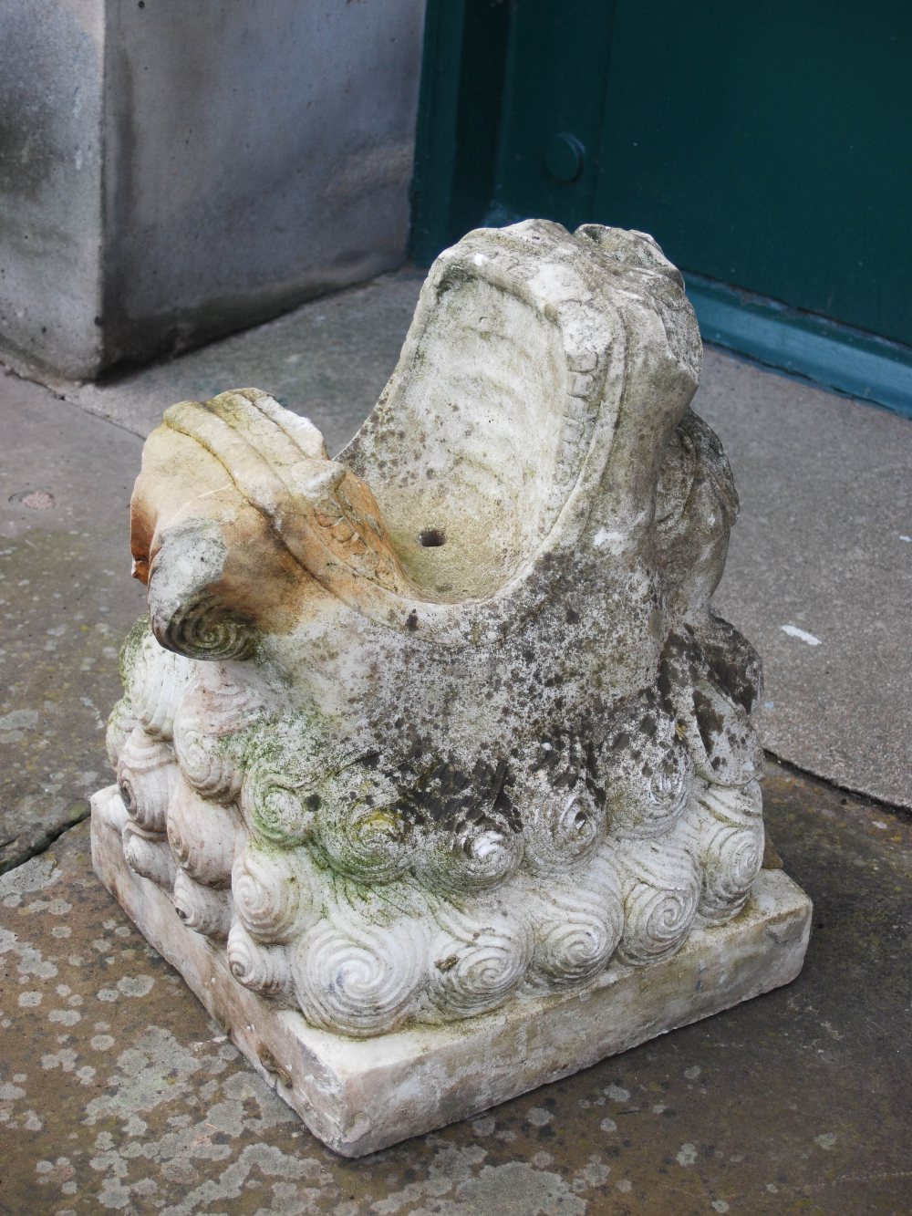 A Chinese marble fountain head carved in the form of a dragon with open mouth, on square plinth,