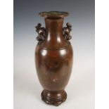 A Chinese bronze and silver inlaid vase, Qing Dynasty, decorated with circular shaped panels of