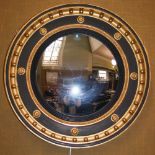 A 19th century Regency style gilt wood convex wall mirror, the circular mirror plate within a floral