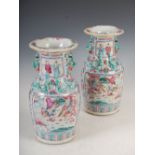 A pair of Chinese porcelain famille rose Canton vases, Qing Dynasty, decorated with panels of
