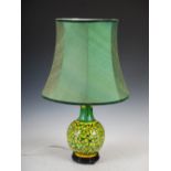 A Chinese porcelain yellow ground bottle vase converted to a table lamp, on integral pierced wood