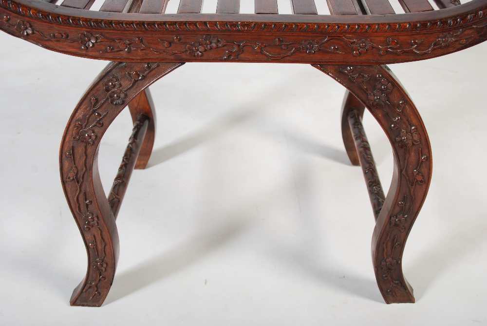 A Chinese dark wood X-frame stool, Qing Dynasty, carved with blossom, 71cm wide x 63cm high x 38cm - Image 4 of 4