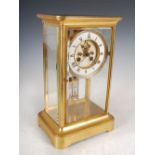 A late 19th century gilt metal mantel clock, the white enamel dial with Roman numerals inscribed W.