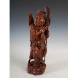 A Chinese carved wood figure of a warrior, late 19th/ early 20th century, 40cm high.