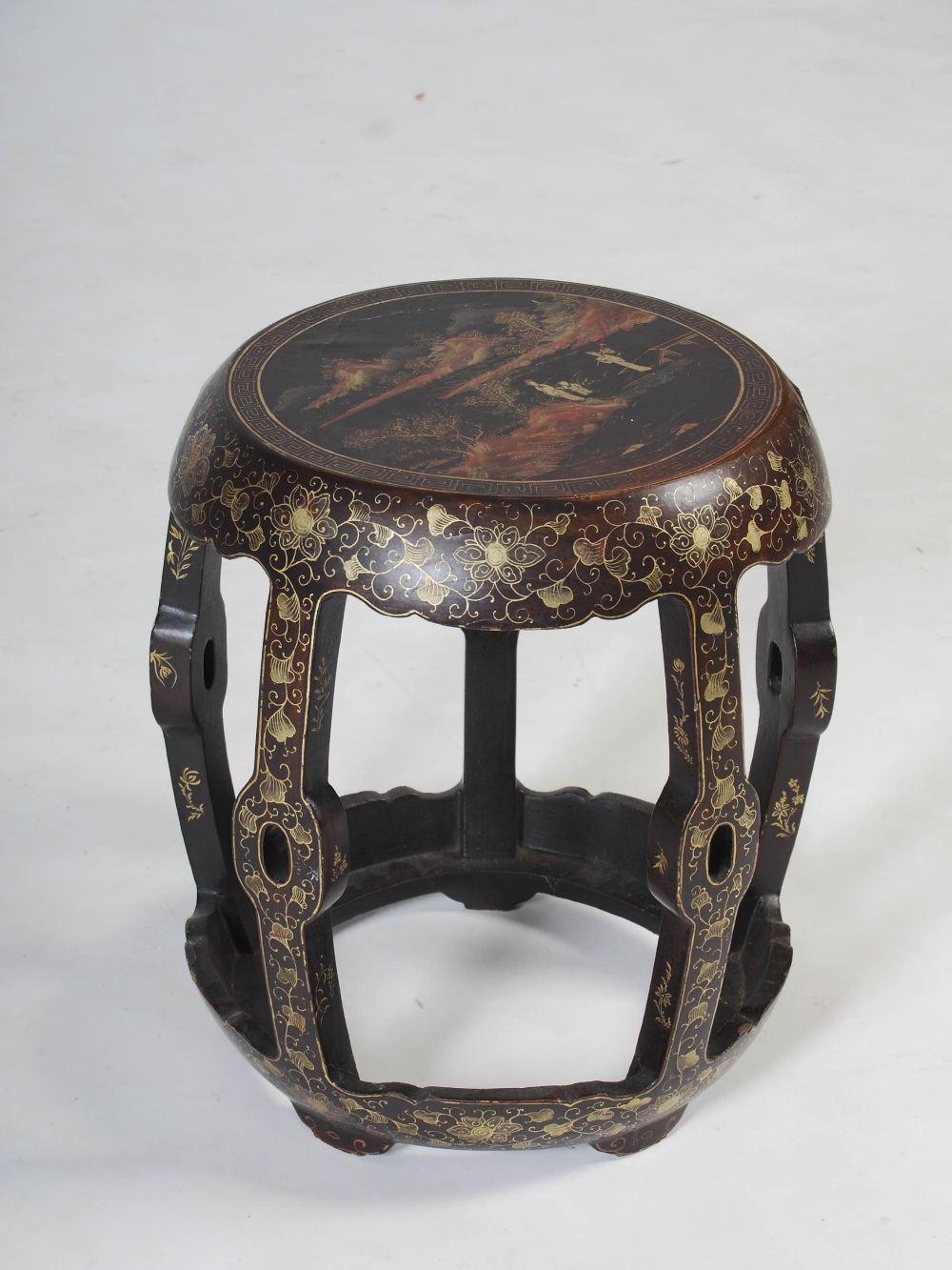 A Chinese lacquered drum shaped stool, Qing Dynasty, decorated with a circular panel of figures