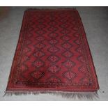 A Tekke rug, the madder ground with five rows of lozenge shaped medallions within repeating