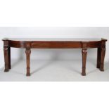 An impressive William IV mahogany serving table, the shaped rectangular top above two blind frieze