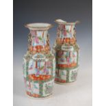 A pair of Chinese porcelain famille rose Canton vases, Qing Dynasty, decorated with panels of