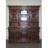 A late 19th century oak sideboard, the upright back with two bevelled mirror recesses and two