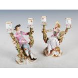 A pair of Meissen porcelain two light figural candelabra, the male figure with blue crossed swords