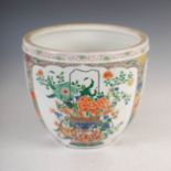 A Chinese porcelain famille verte jardiniere, decorated with three panels of baskets issuing