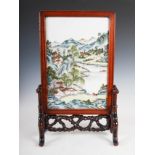 A Chinese porcelain table screen, late 19th/early 20th century, decorated with figures and pavilions