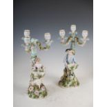 A pair of Sitzendorf porcelain three light candelabra, the scrolling branches and urn shaped nozzles