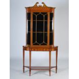 A 19th century painted satinwood display cabinet, the associated top with a broken scroll pediment