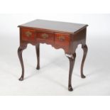 A George III style mahogany low boy, the rectangular top with a moulded edge, above three frieze