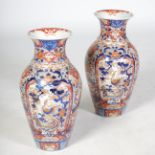 A large pair of Japanese Imari porcelain vases, Meiji Period, decorated with panels of long tailed