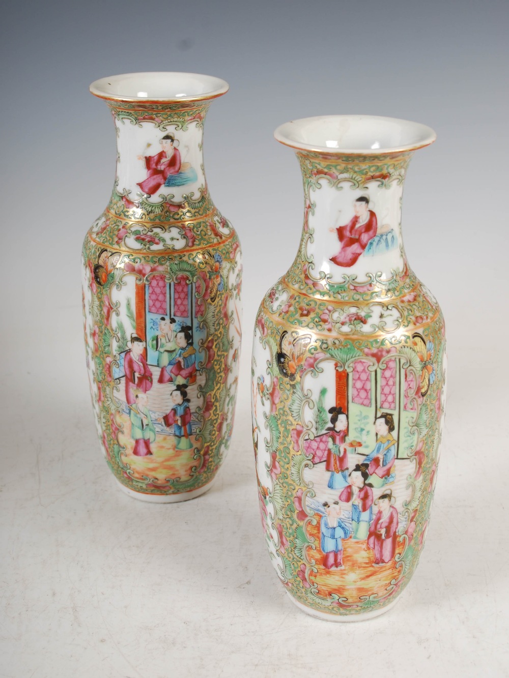 A pair of Chinese porcelain famille rose Canton vases, Qing Dynasty, decorated with panels of