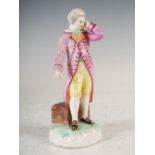 A 19th century Continental porcelain figure group modelled as an 18th century gentleman wearing a