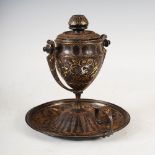 A late 19th century oil lamp, the hinged oval shaped reservoir on a lyre shaped support and domed