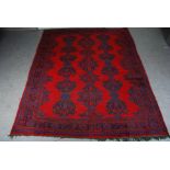 An Ushak red ground carpet, the rectangular field centred with three rows of stylised foliate